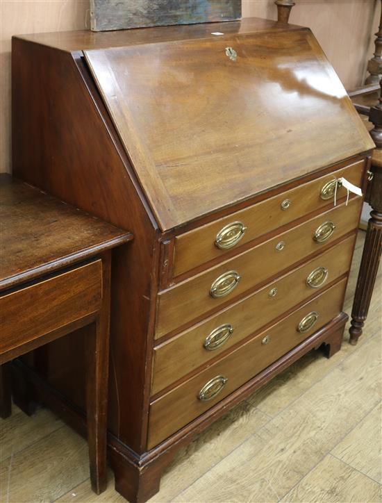 A mahogany bureau fitted four graduated long drawers W.101cm